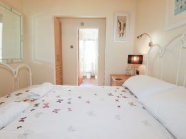 A bedroom with a bed and door to bathroom at St Minver Holiday Park - Holiday Accommodation 21443, Wadebridge