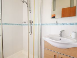 A bathroom with a shower, sink, and mirror at St Minver Holiday Park - Holiday Accommodation 21443 Wadebridge