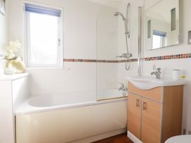 A bathroom with a bathtub and shower at St Minver Holiday Park - Holiday Accommodation 21443 Wadebridge