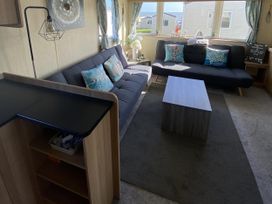 A living room with sofas and a coffee table at Devon Cliffs Holiday Park - Holiday Accommodation 21624, Exmouth