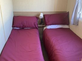 Two single beds in a bedroom at Devon Cliffs Holiday Park - Holiday Accommodation 21624 Exmouth