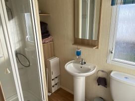 A bathroom with a sink, shower, and toilet at Devon Cliffs Holiday Park - Holiday Accommodation 21624 Exmouth