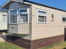 A caravan with windows and a number sign at Brightholme Holiday Park - Holiday Accommodation 21925 in Brean,near Burnham On Sea
