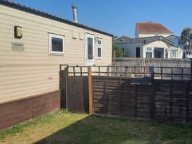 A caravan with a fenced area at Brightholme Holiday Park - Holiday Accommodation 21925 Brean,near Burnham On Sea