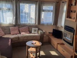 A living room with a sofa and television at Brightholme Holiday Park - Holiday Accommodation 21925, Brean,near Burnham On Sea