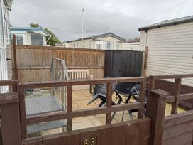 An outdoor area with seating and a storage shed at Brightholme Holiday Park - Holiday Accommodation 21925 Brean,near Burnham On Sea