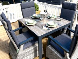 An outdoor dining area with a table and chairs at Aberdunant Hall Holiday Park - Holiday Accommodation 21962 in Prenteg