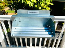 A metal holder for disposable barbecues in an outdoor setting at Aberdunant Hall Holiday Park - Holiday Accommodation 21962 Prenteg