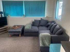A living room with a sofa and television at Golden Gate Holiday Centre - Holiday Accommodation 22147 Towyn