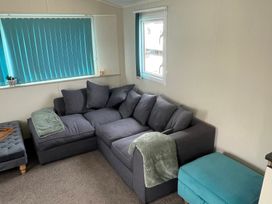 A living room with a sofa and cushions at Golden Gate Holiday Centre - Holiday Accommodation 22147 Towyn