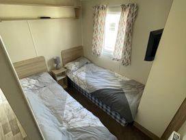 A bedroom with two beds and a window at Golden Gate Holiday Centre - Holiday Accommodation 22147 Towyn