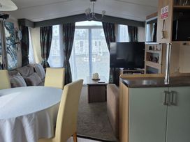 A living room with furniture and a television at Ty Gwyn Caravan Park - Holiday Accommodation 22189 Abergele