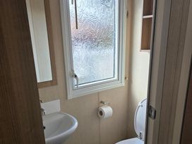 A bathroom with a sink and toilet at Ty Gwyn Caravan Park - Holiday Accommodation 22189 Abergele