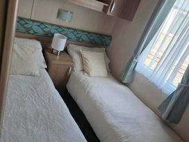 A bedroom with two single beds at Ty Gwyn Caravan Park - Holiday Accommodation 22189 Abergele