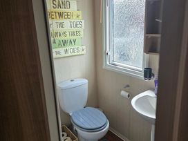 A bathroom featuring a toilet and sink at Ty Gwyn Caravan Park - Holiday Accommodation 22189 Abergele