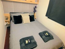 A bedroom with a bed and pillows at Kingfisher Caravan Park - Holiday Accommodation 22193, Ingomells