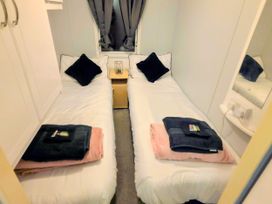 A bedroom with two single beds at Kingfisher Caravan Park - Holiday Accommodation 22193 in Ingomells