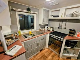 A kitchen with stove and sink at Kingfisher Caravan Park - Holiday Accommodation 22193 in Ingomells