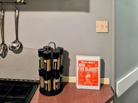 A spice rack and fire blanket in a kitchen at Kingfisher Caravan Park - Holiday Accommodation 22193 in Ingomells