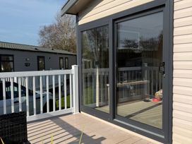 An outdoor patio with a door leading inside at Hafan y Mor Haven - Holiday Accommodation 22224 Pwllheli