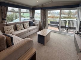 A living room with sofa and coffee table at Hafan y Mor Haven - Holiday Accommodation 22224 in Pwllheli