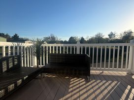 Outdoor seating area with furniture and a view at Hafan y Mor Haven - Holiday Accommodation 22224 Pwllheli