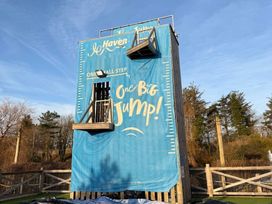A jump tower with a safety mat and ladder at Hafan y Mor Haven - Holiday Accommodation 22224 Pwllheli