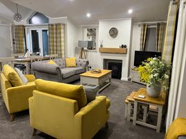 A living room with a sofa and armchairs at White Acres Holiday Park - Holiday Accommodation 22327, Whitecross, Newquay