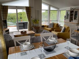 A living room with a table and chairs at White Acres Holiday Park - Holiday Accommodation 22327 in Whitecross, Newquay