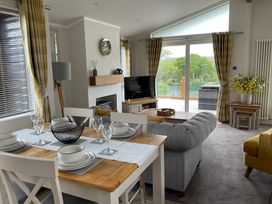 A living room with a dining table and sofa at White Acres Holiday Park - Holiday Accommodation 22327, Whitecross, Newquay