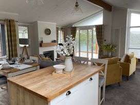 A living room with a dining area and seating at White Acres Holiday Park - Holiday Accommodation 22327, Whitecross, Newquay