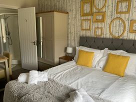 A bedroom with a bed and wardrobe at White Acres Holiday Park - Holiday Accommodation 22327, Whitecross, Newquay