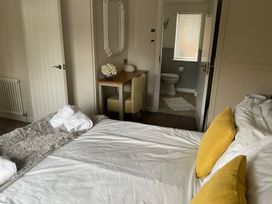 A bedroom with a bed and a table in view at White Acres Holiday Park - Holiday Accommodation 22327, Whitecross, Newquay