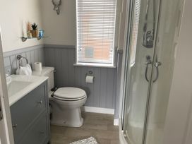 A bathroom with a sink and shower at White Acres Holiday Park - Holiday Accommodation 22327 Whitecross, Newquay