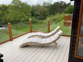 An outdoor balcony with loungers at White Acres Holiday Park - Holiday Accommodation 22327, Whitecross, Newquay