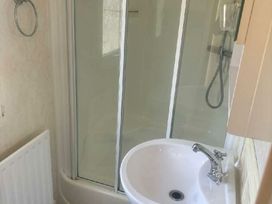 a bathroom with a shower stall and a sink at Coral Beach - Holiday Accommodation 22375 in Ingoldmells