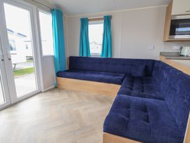 A living room with a sofa and window at Ty Mawr Holiday Park - Holiday Accommodation 22393 Towyn