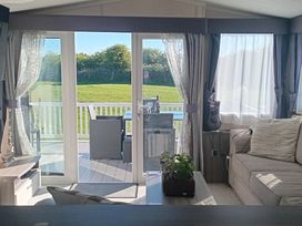 A living room with a sofa and coffee table at Primrose Valley Holiday Park - Holiday Accommodation 2533 in Filey