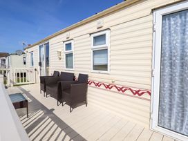 A patio area with seating and table at Coastfield Holiday Village - Holiday Accommodation 2604 Ingoldmells