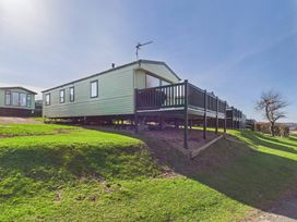 A static caravan with a deck at St Andrews Holiday Park - Holiday Accommodation 2944 St Andrews
