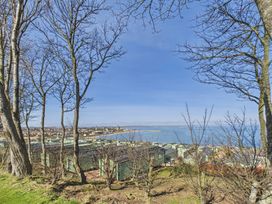 A view of the sea and huts from a hillside with trees at St Andrews Holiday Park - Holiday Accommodation 2944 St Andrews