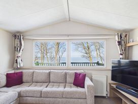A living room with a sofa and television at St Andrews Holiday Park - Holiday Accommodation 2944 St Andrews