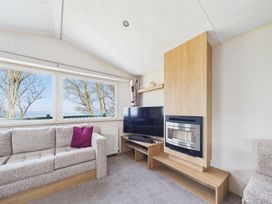 A living room with a sofa and television at St Andrews Holiday Park - Holiday Accommodation 2944, St Andrews