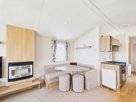 A living room with a table and sofa at St Andrews Holiday Park - Holiday Accommodation 2944 in St Andrews