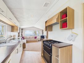 A kitchen and living room with appliances and furniture at St Andrews Holiday Park - Holiday Accommodation 2944 St Andrews