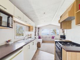 A kitchen with appliances and seating area at St Andrews Holiday Park - Holiday Accommodation 2944 in St Andrews