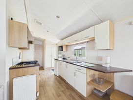 A kitchen with cabinets and appliances at St Andrews Holiday Park - Holiday Accommodation 2944, St Andrews