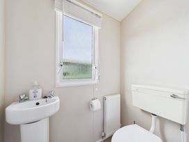 A bathroom with a sink and toilet at St Andrews Holiday Park - Holiday Accommodation 2944 St Andrews
