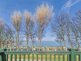 View of the sea with trees and buildings at St Andrews Holiday Park - Holiday Accommodation 2944 St Andrews