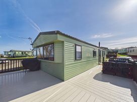 A caravan with a deck and outdoor furniture at St Andrews Holiday Park - Holiday Accommodation 2944 St Andrews